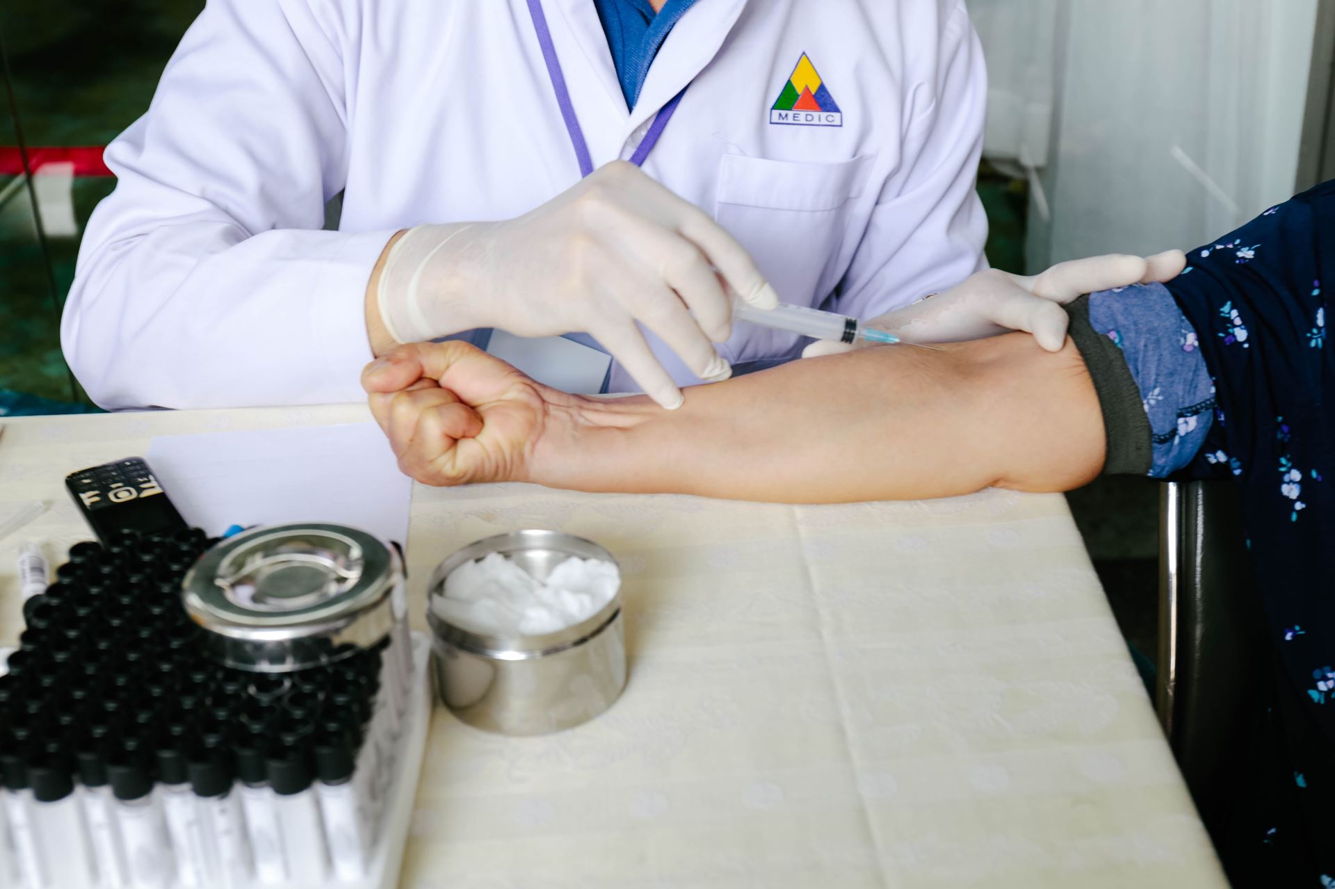 a person sitting on a table getting a vaccination